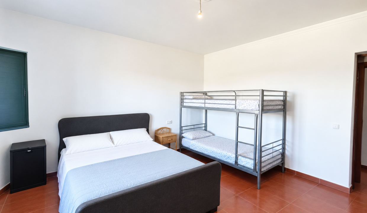 Dormitorio minimalista con literas y cama doble